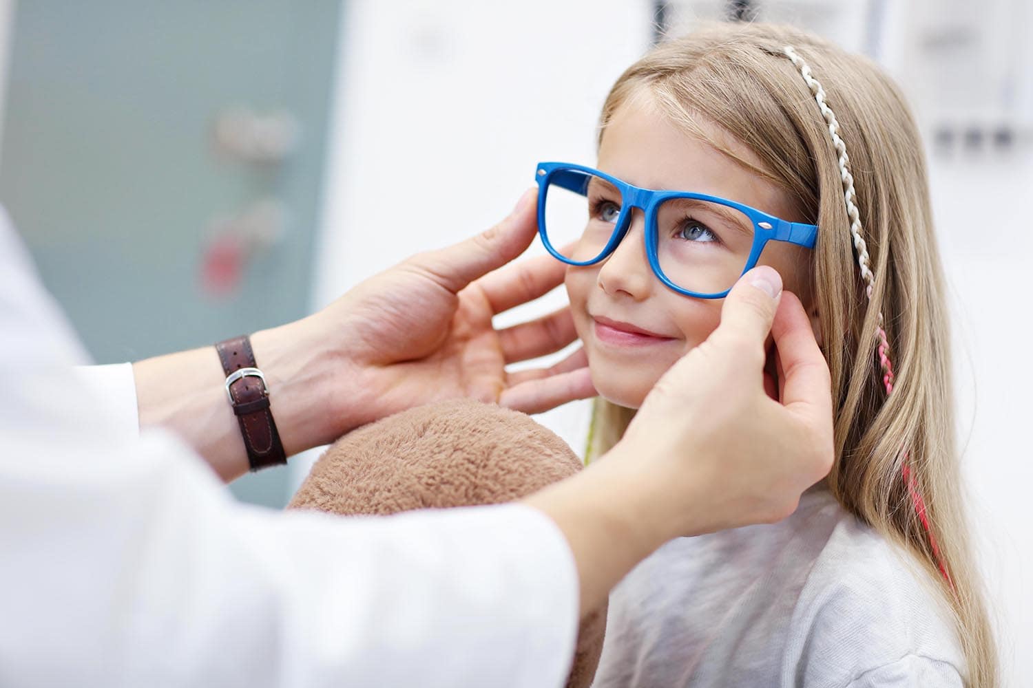 Picture of child optometry male optometrist optician doctor examines eyesight of little girl